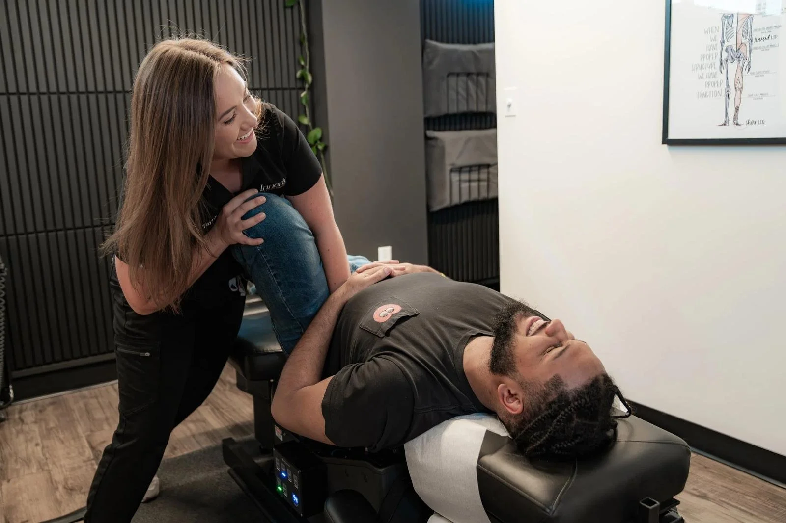 Chiropractor performing a neck adjustment on a patient at InnerLux in Denver
