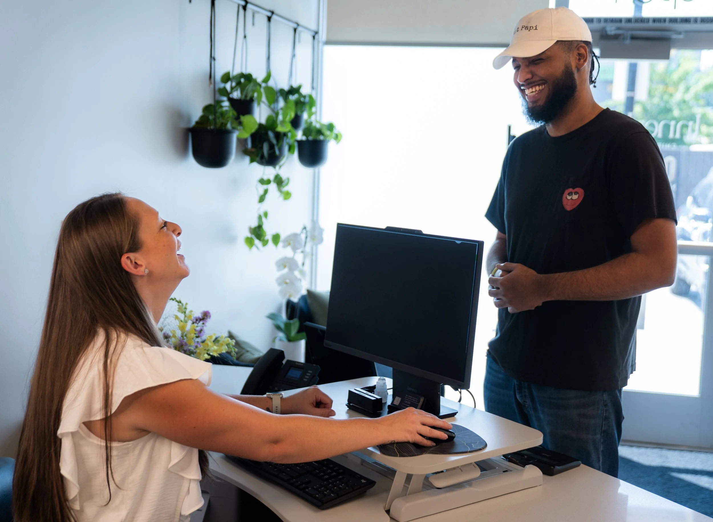 Patient checking in at the front desk of InnerLux Healing Collective in Denver