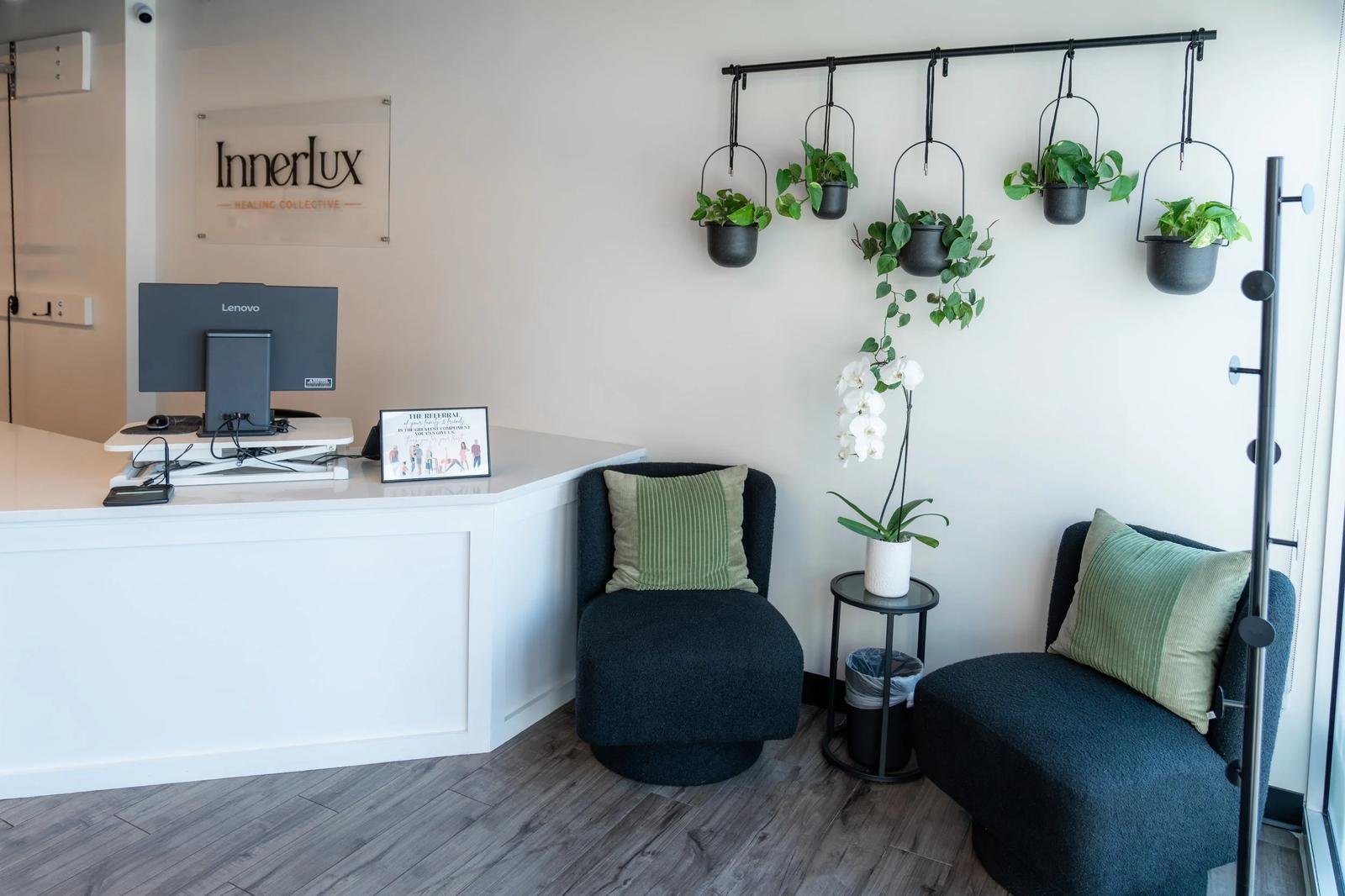 Reception desk and waiting area at InnerLux Healing Collective in Denver, CO.