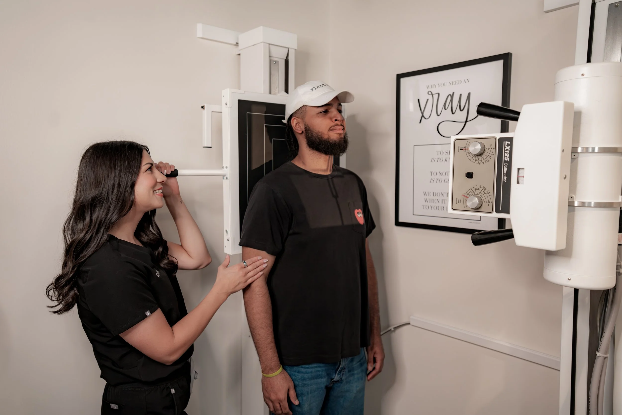 Patient positioned for a digital spinal X-ray at InnerLux chiropractic in Denver