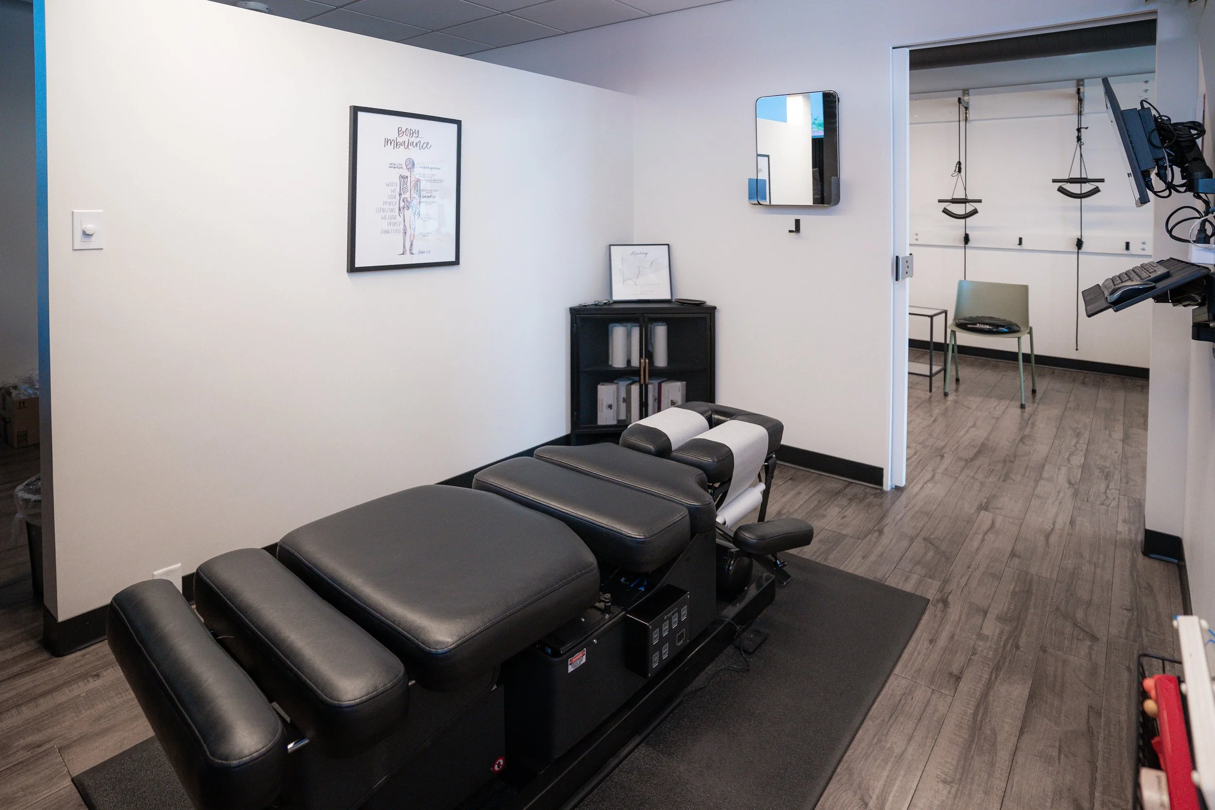 Chiropractic adjusting tables in a treatment room at InnerLux in Denver