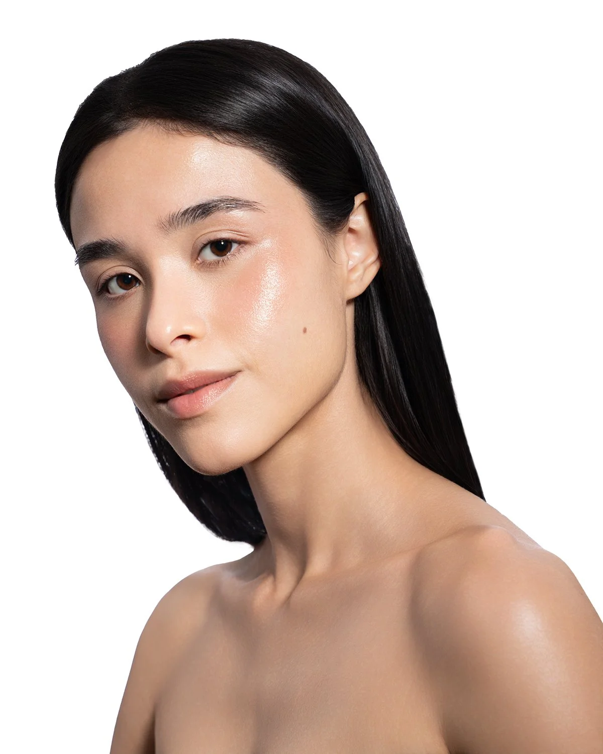 Close-up portrait of a woman with clear, glowing skin and long, straight black hair, looking confidently at the camera against a white background.