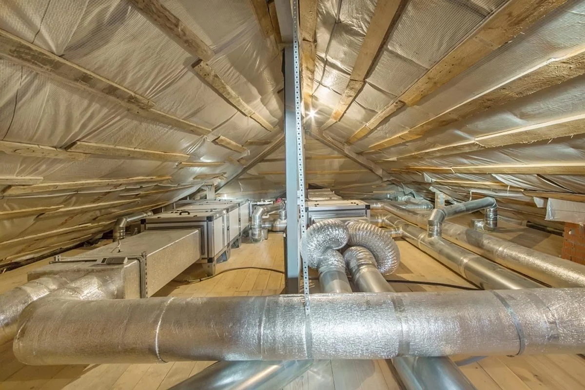 Attic space with ductwork and air conditioning units installed.