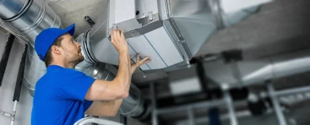 A technician installs or repairs HVAC ductwork in a commercial or industrial building.