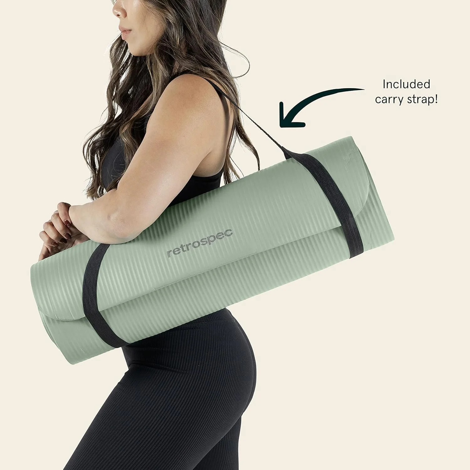 Woman carrying a green yoga mat with a black strap, labeled 'retrospec', over her shoulder. An arrow points to the strap with a note 'Included carry strap!'