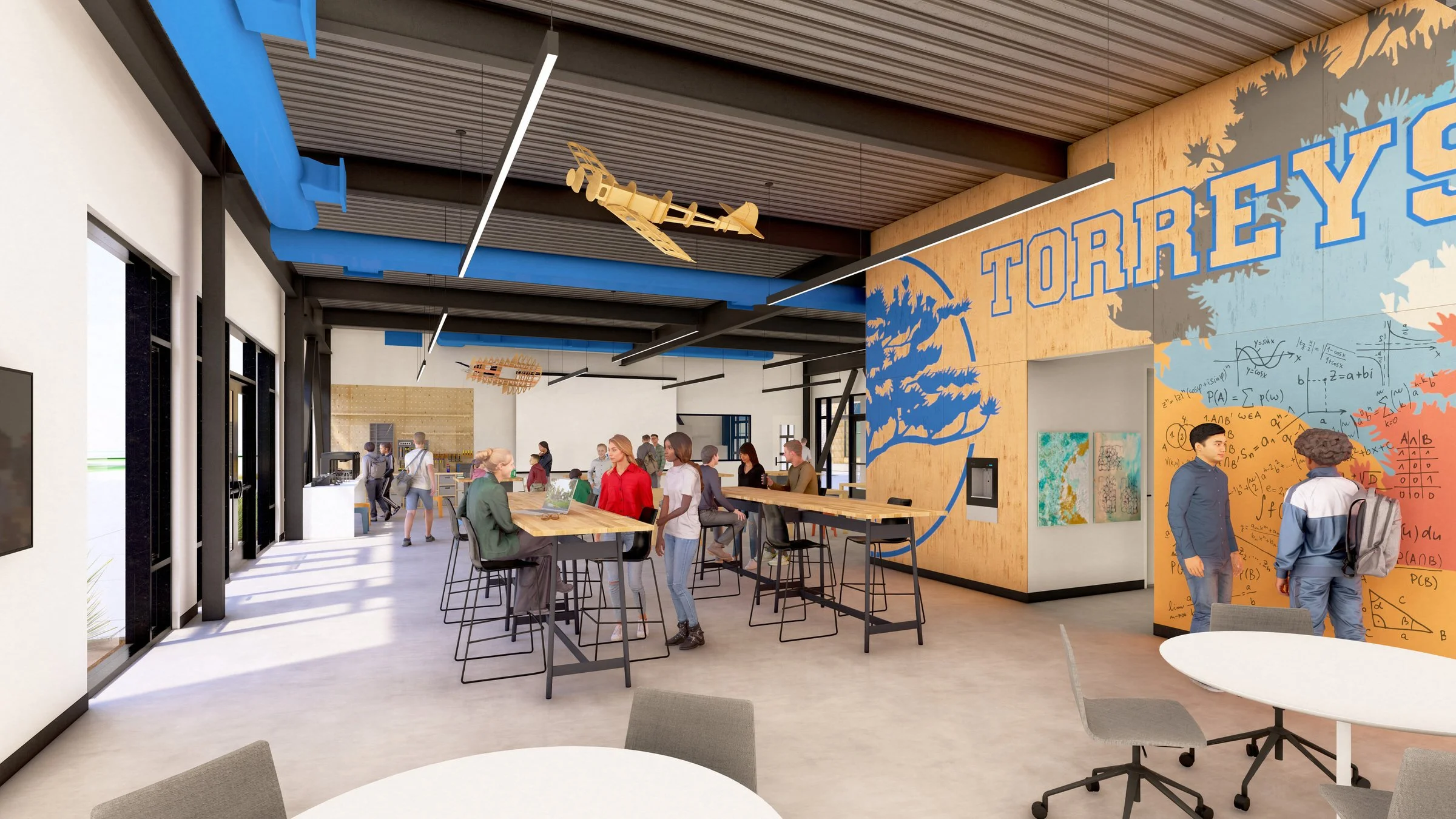 A modern, open-plan workspace with high ceilings and industrial design. People are sitting and standing around tall tables, engaging in conversation. The walls feature colorful murals and a large "Torrey's" sign. Visible wooden models hang from the c