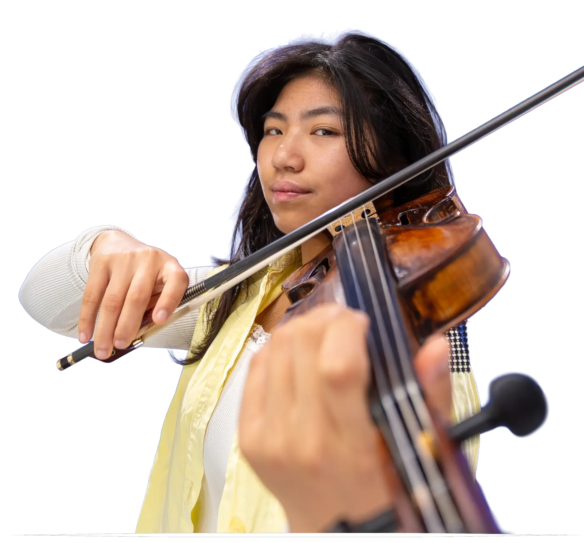 Young woman playing the violin, wearing a yellow shirt and cream sweater, with a white background.