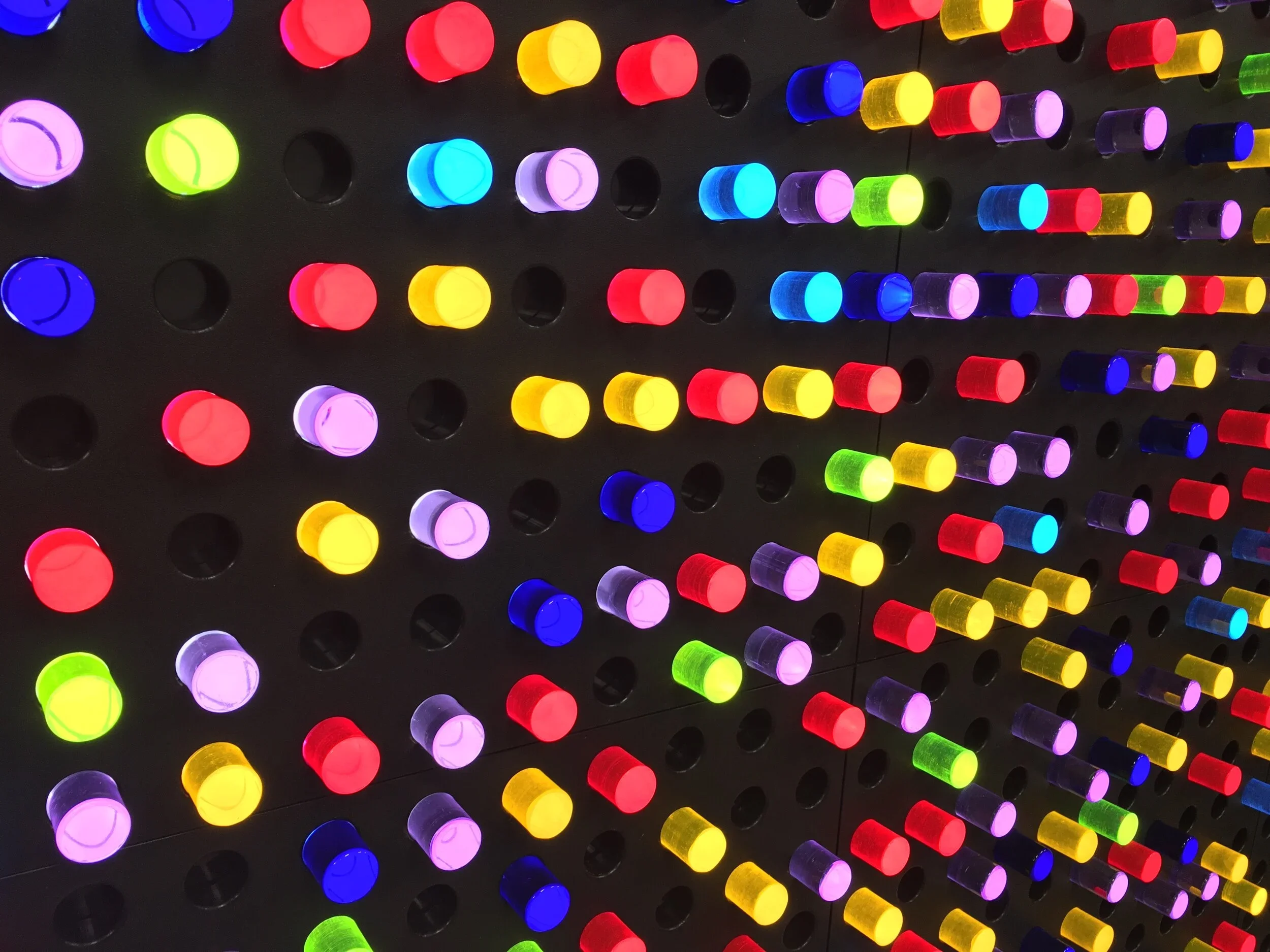 Colorful illuminated LED lights arranged in a grid pattern on a dark background.