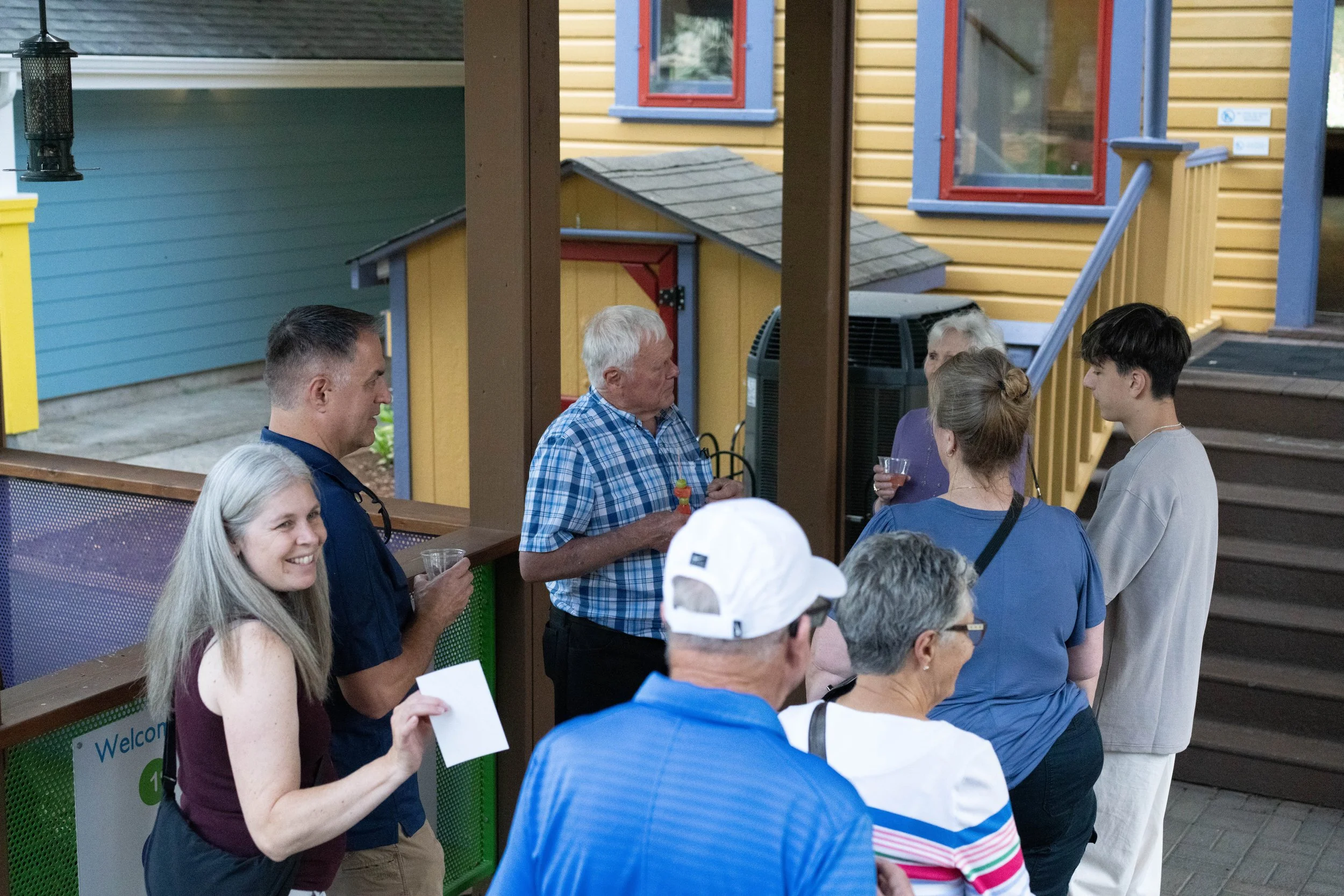 Multi-generational guests gathering at the museum to view the interns' large-scale mural installations.