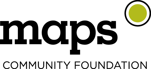 A black cat sitting on a telephone wire with a green circle in the upper right corner.