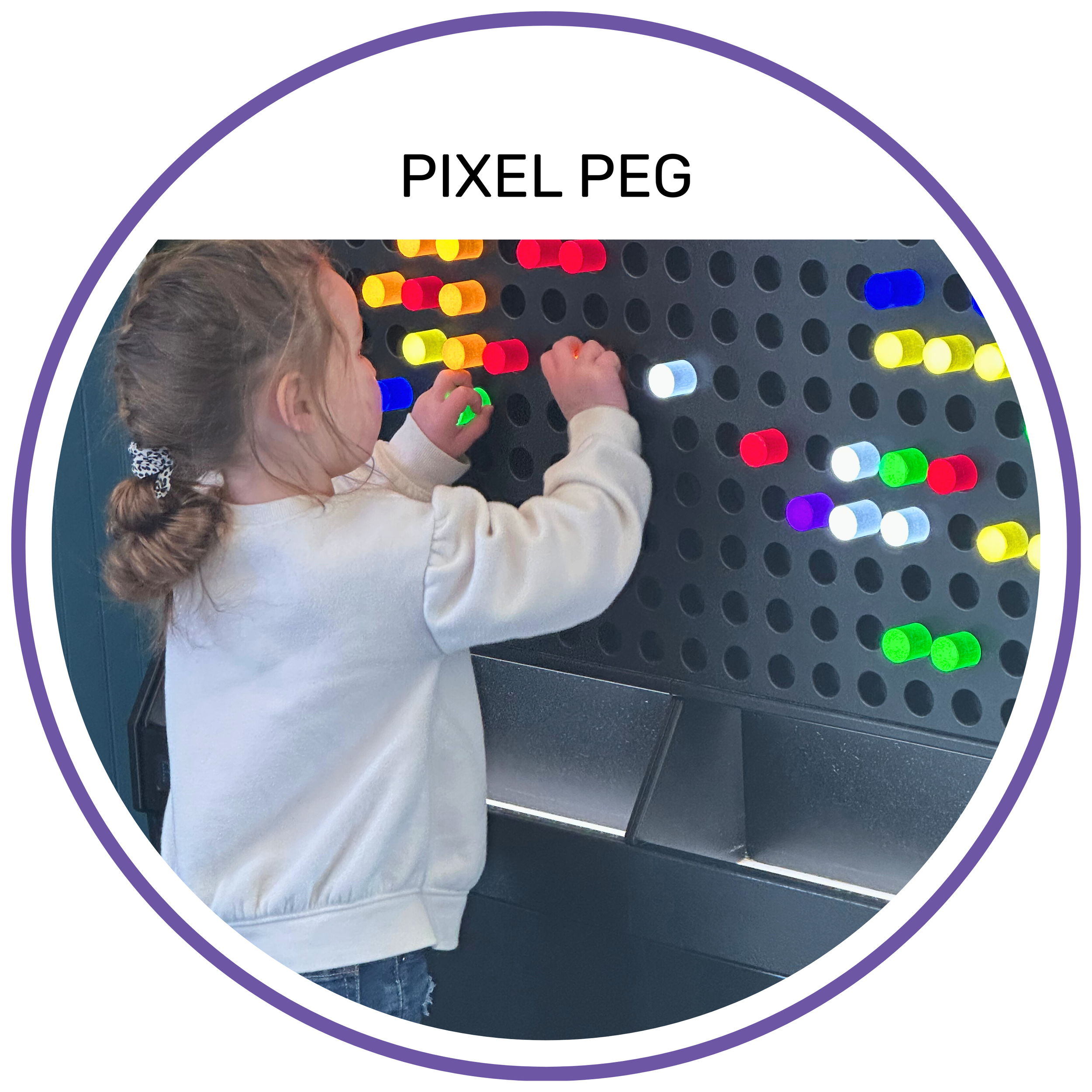 Young girl creating a colorful design on a large, lit-up pegboard wall exhibit.