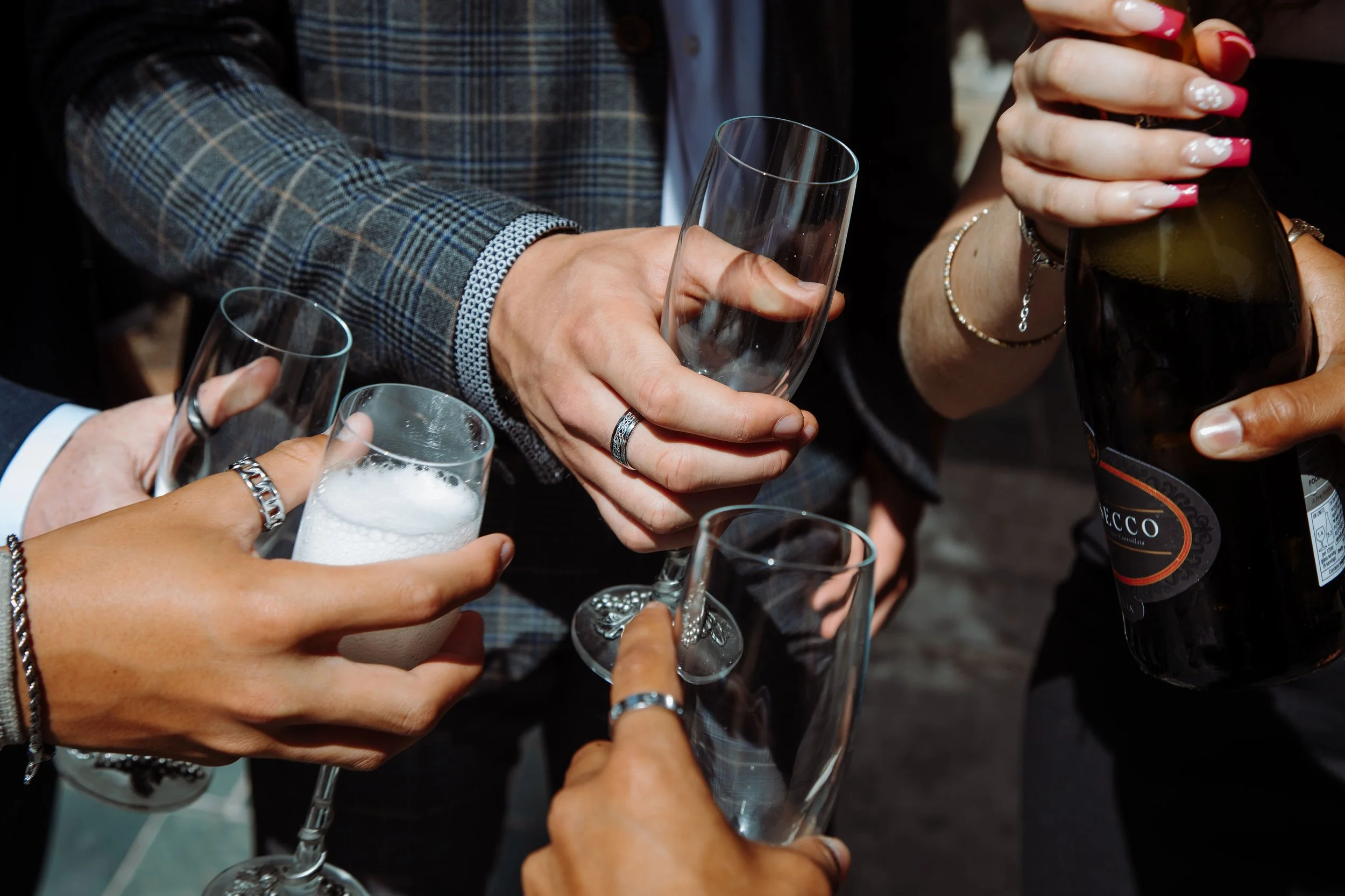 Young people pouring alcoholic drinks