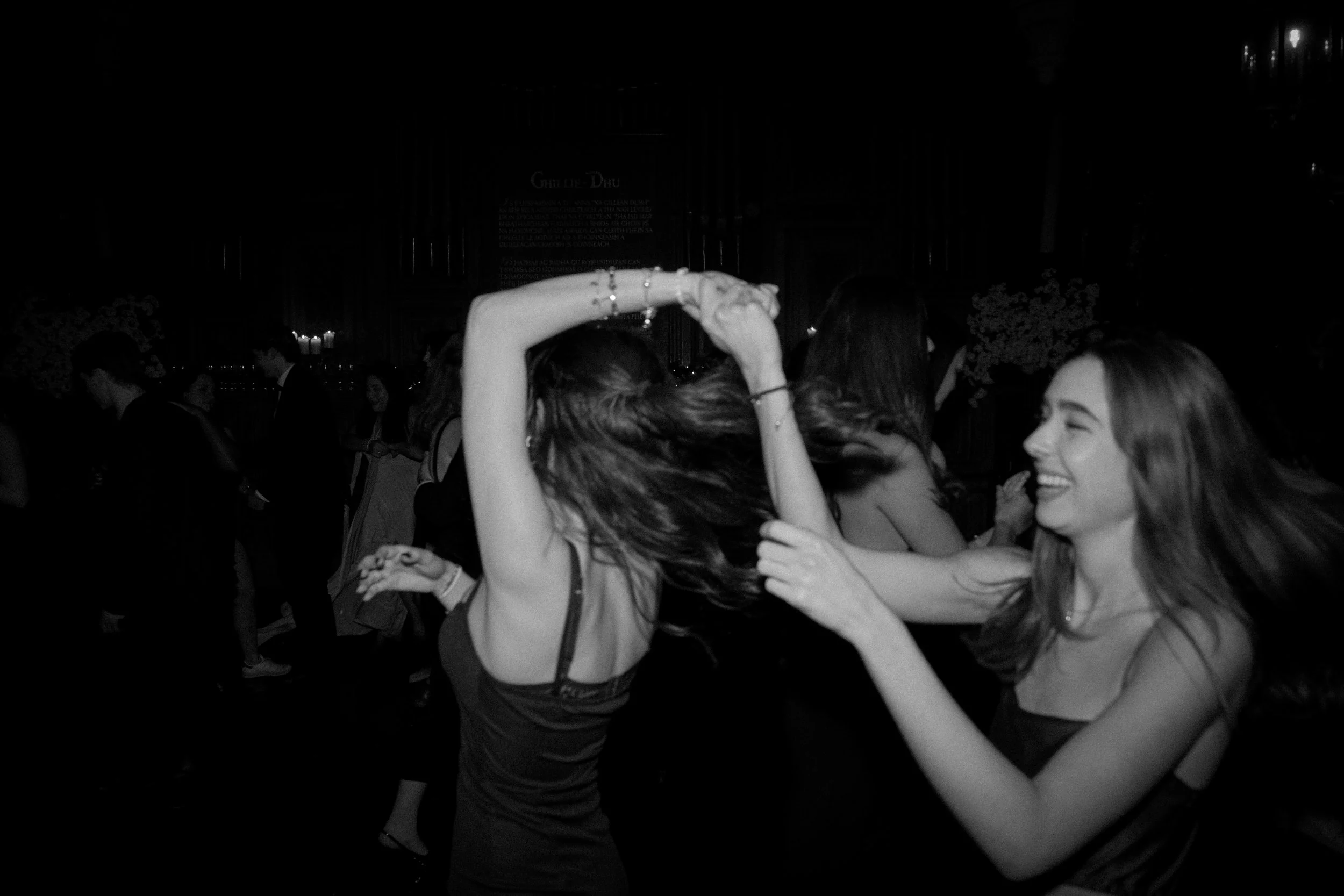 People dancing and smiling at a party or celebration.