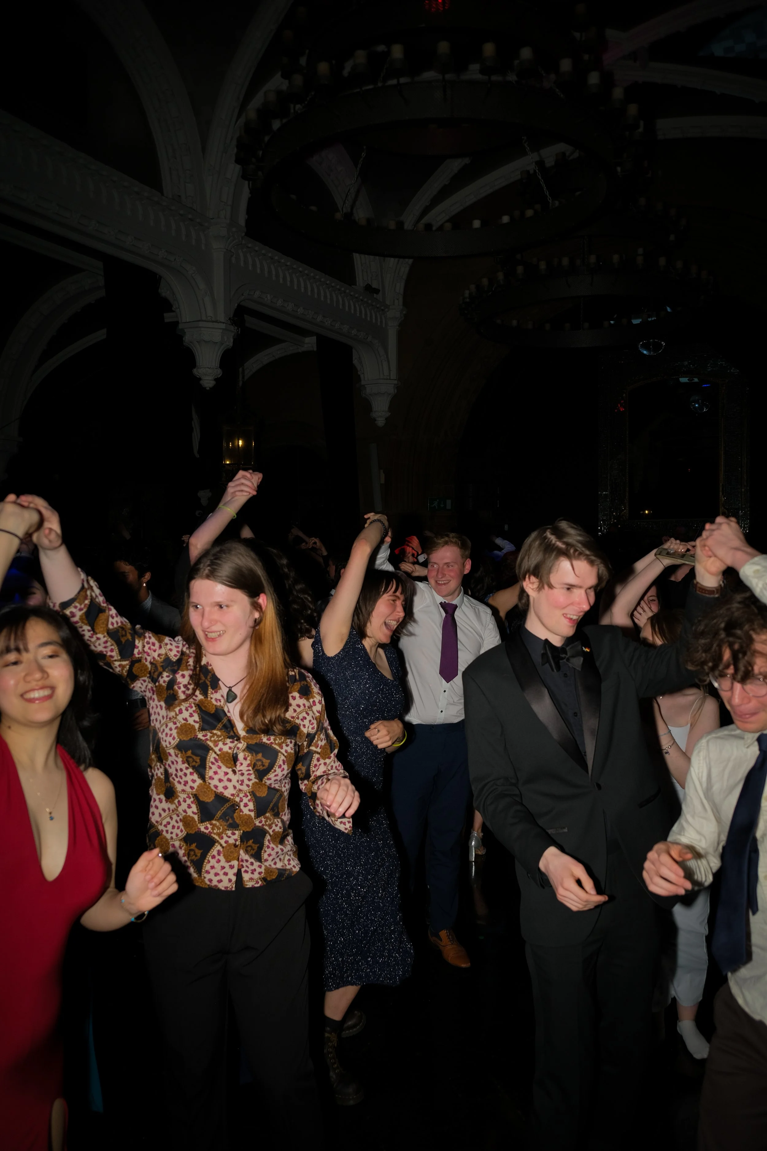 People dancing at a crowded indoor party or dance event.