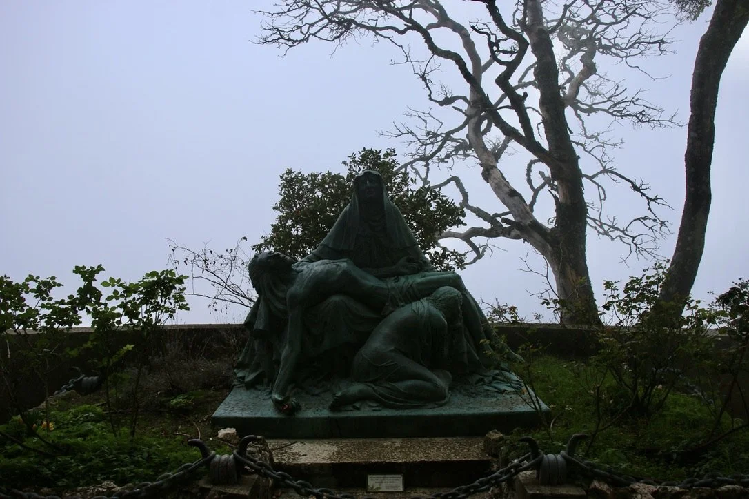 A version of the classic pieta right outside the cave entrance, with Mary Magdalene kneeling at Jesus' feet