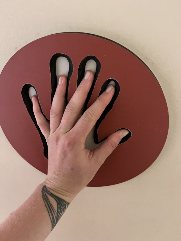 A cut out of a handprint found in a painting