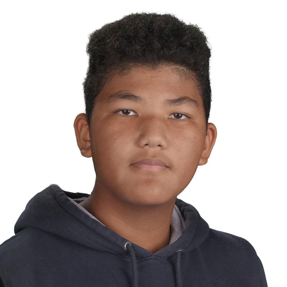 Portrait of a young boy with short curly hair wearing a black hoodie