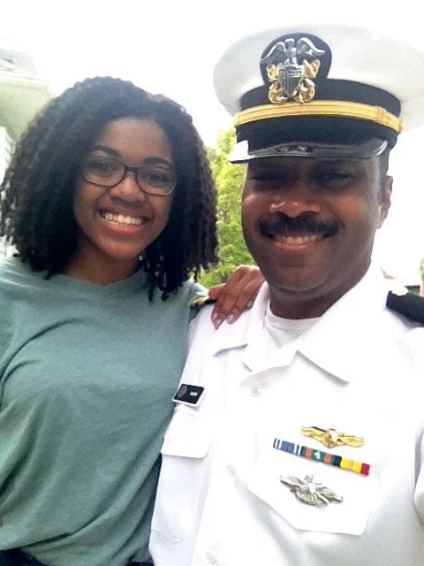 Thomas Gary in his Navy uniform posing proudly with his daughter