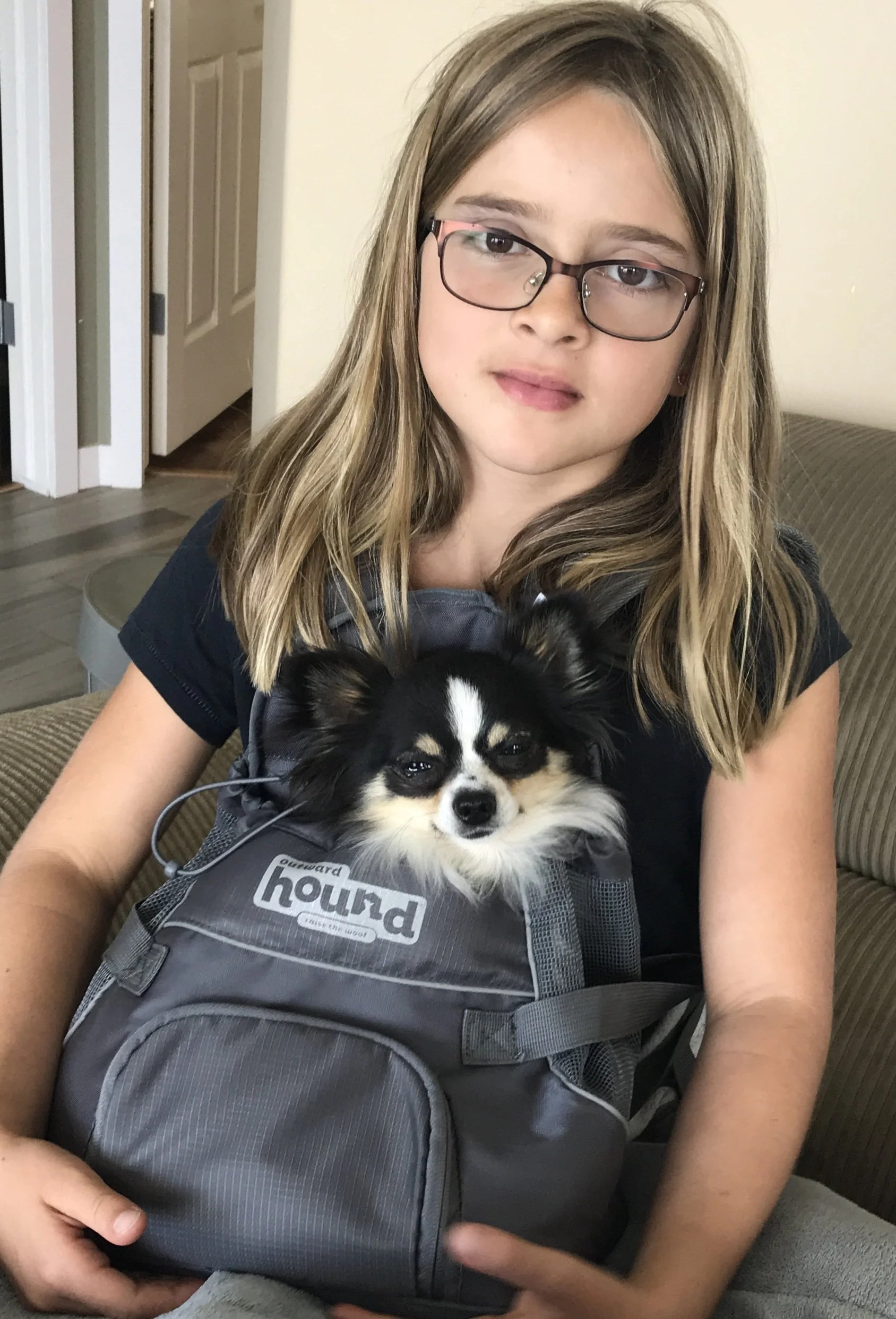 One Blond girl with a chihuahua in a puppy bag.
