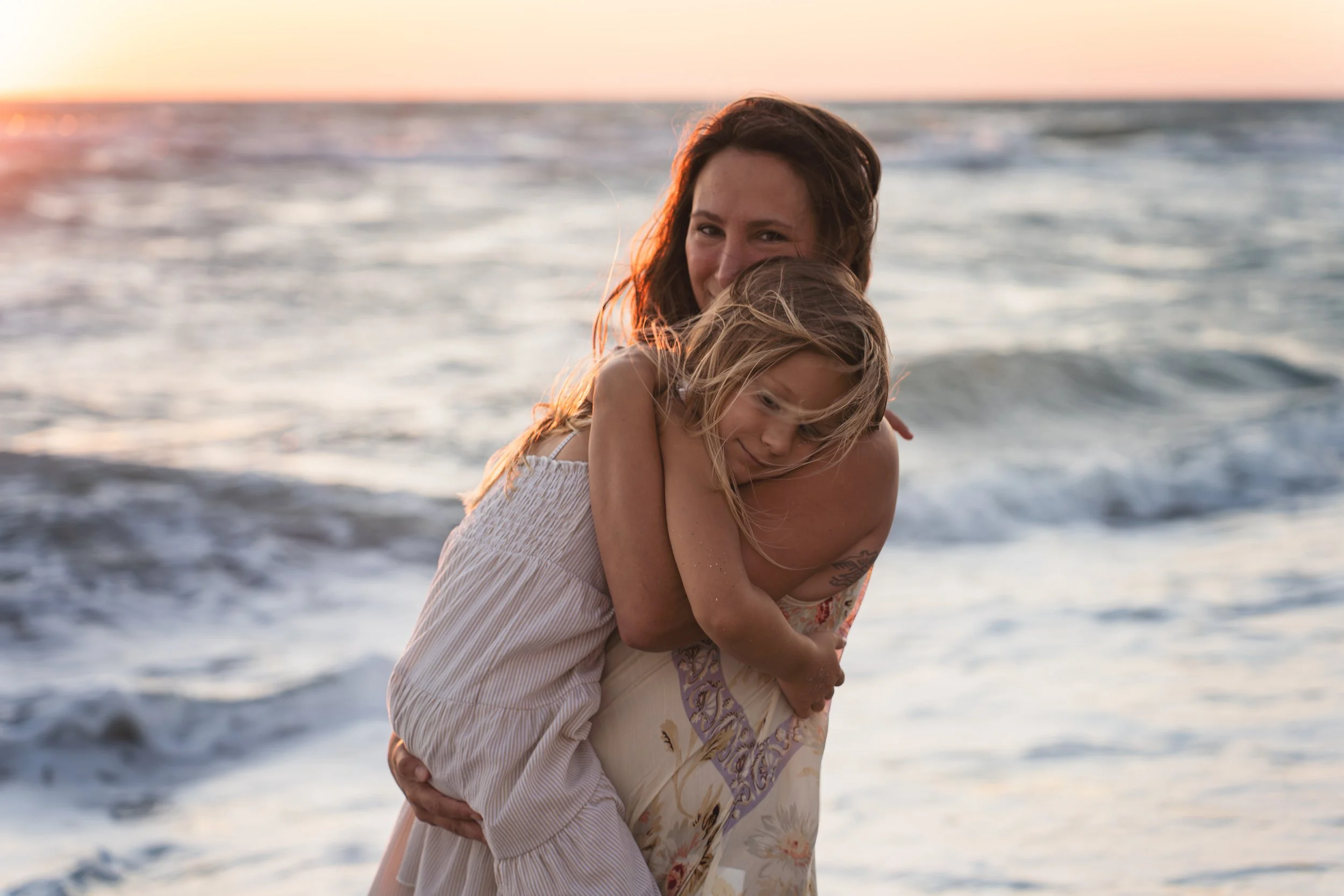 Mom holding daughter on Venice Beach, FL