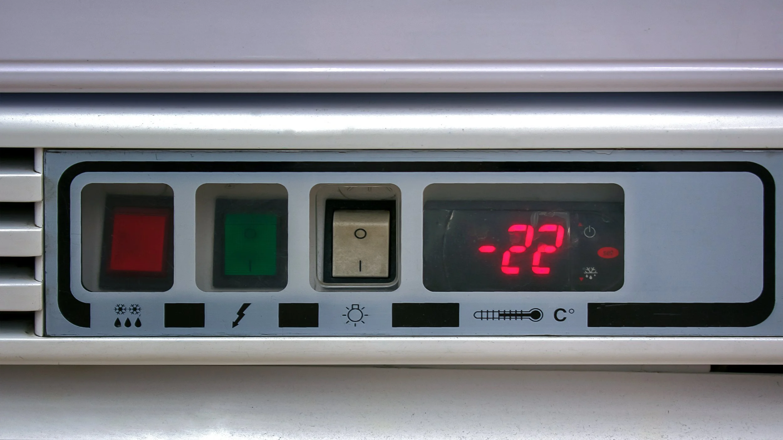 Close-up of a refrigeration unit control panel with temperature display showing -22 degrees Fahrenheit.