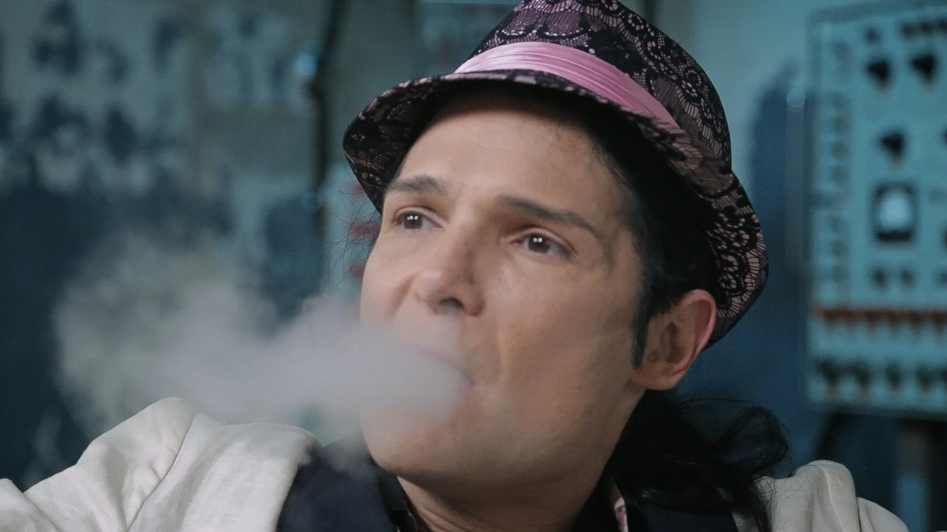 Corey Feldman is exhaling vape smoke backstage.