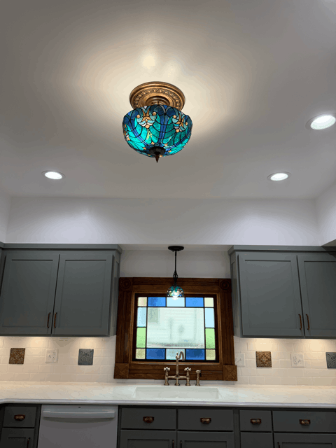  Victorian-inspired kitchen lighting with stained glass ceiling fixture and recessed lighting in remodeled historic home. 