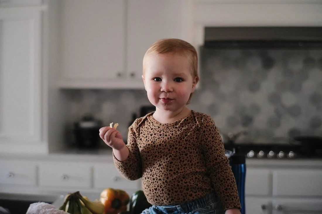 Child standing in a renovated kitchen space, representing family-centered design values at Rural Renovation