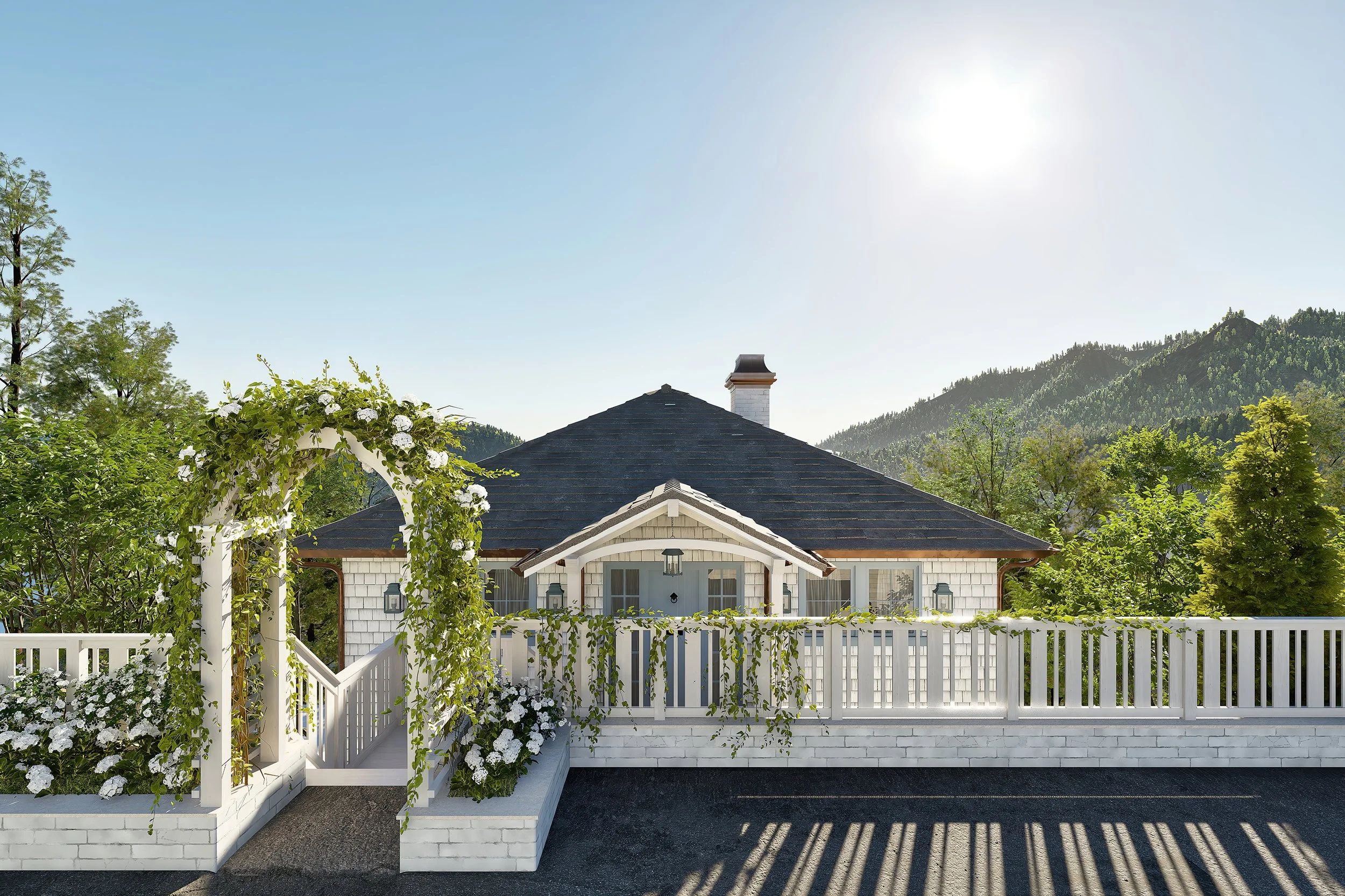 A house with a gray shingled roof, white walls, and a front porch surrounded by a white picket fence, with greenery and trees in the background, set against a mountainous landscape and clear blue sky.
