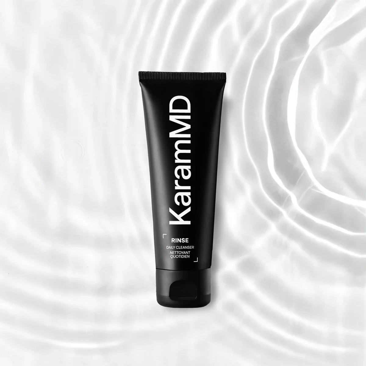 A black tube of Kar'ran MAD rinse daily cleanser with white text on a white textured background.