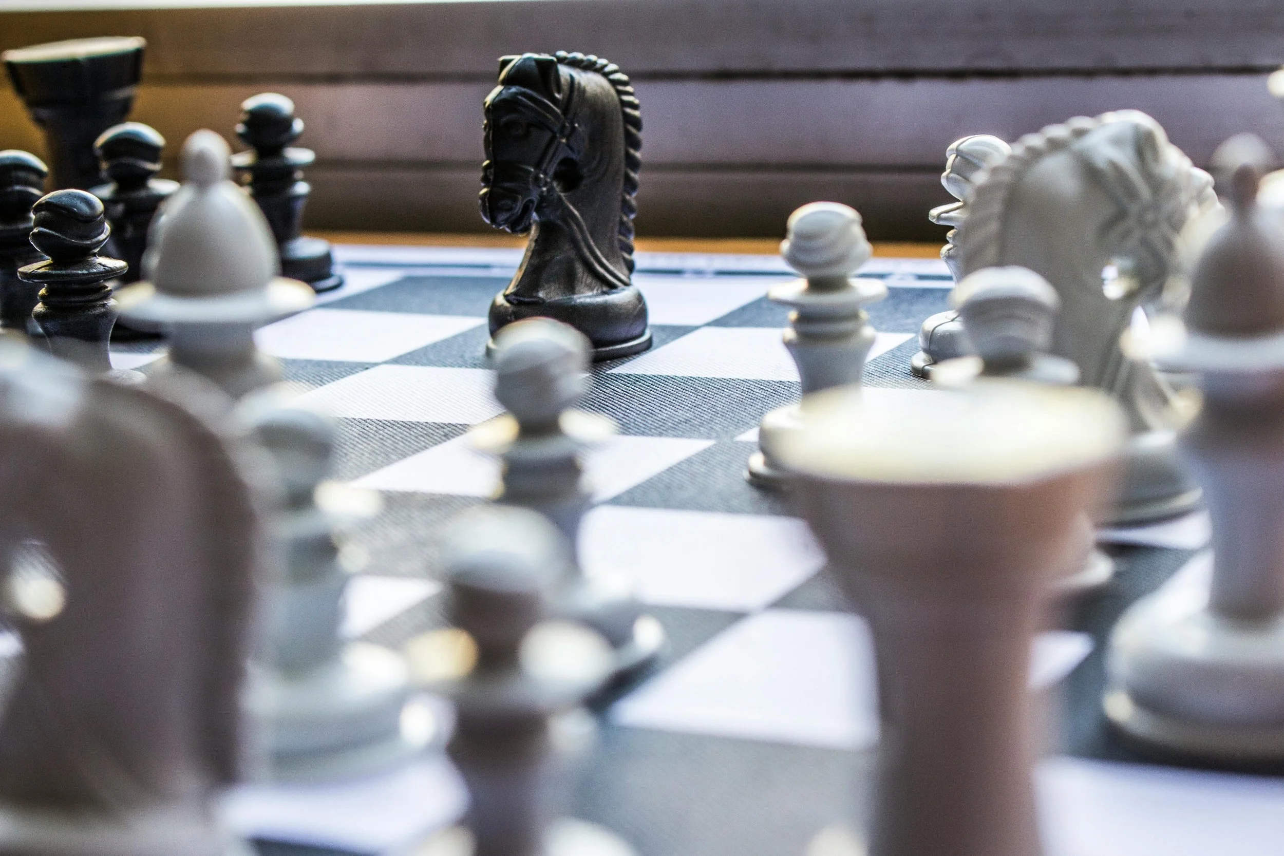 A close up image of a chess board, highlighting one of the pieces. Representing the insights of Joseph Catalino TFBSO on strategic risk modeling.