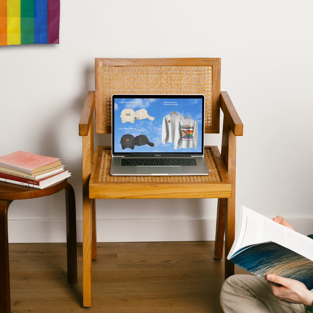 A laptop sitting on a wooden chair displaying Pride Niagara's concept website designed by Steph Parker Designs