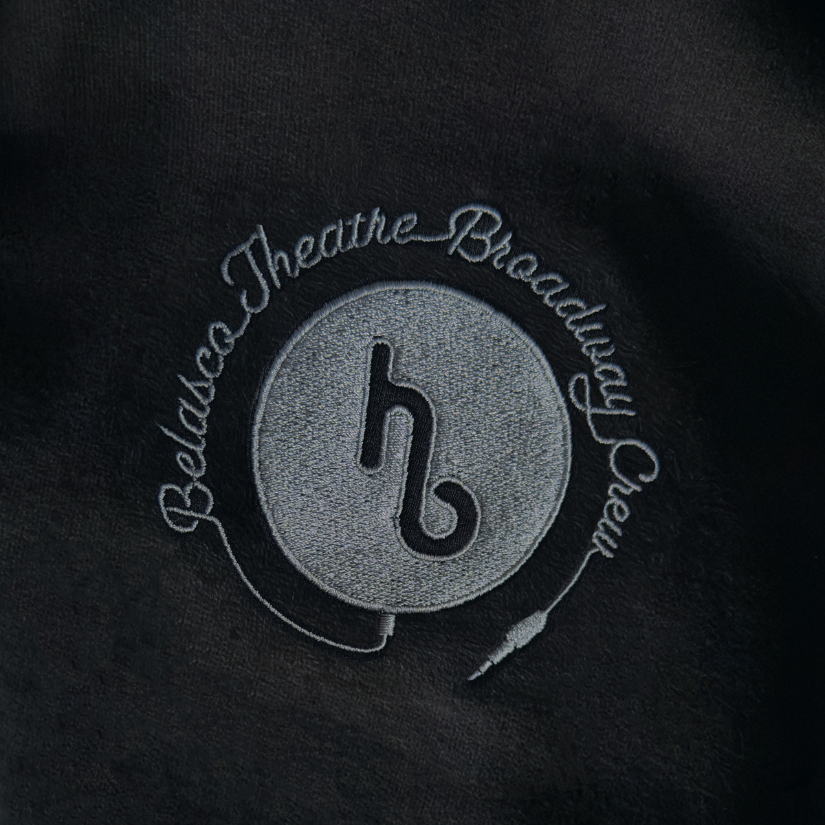 Maybe Happy Ending "Helper Bot" embroidery patch with the text 'Belasco Theatre Broadway and a stylized microphone icon. "Backstage Edition"