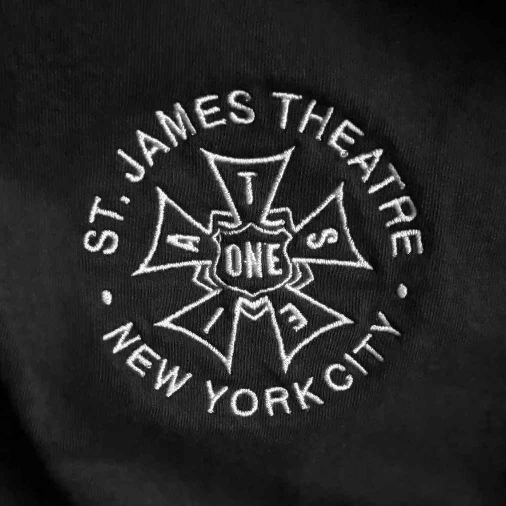 Embroidered logo with the text "ST. JAMES THE ATRE NEW YORK CITY" in a circular design around a IATSE union bug with the number " ONE " in the center.