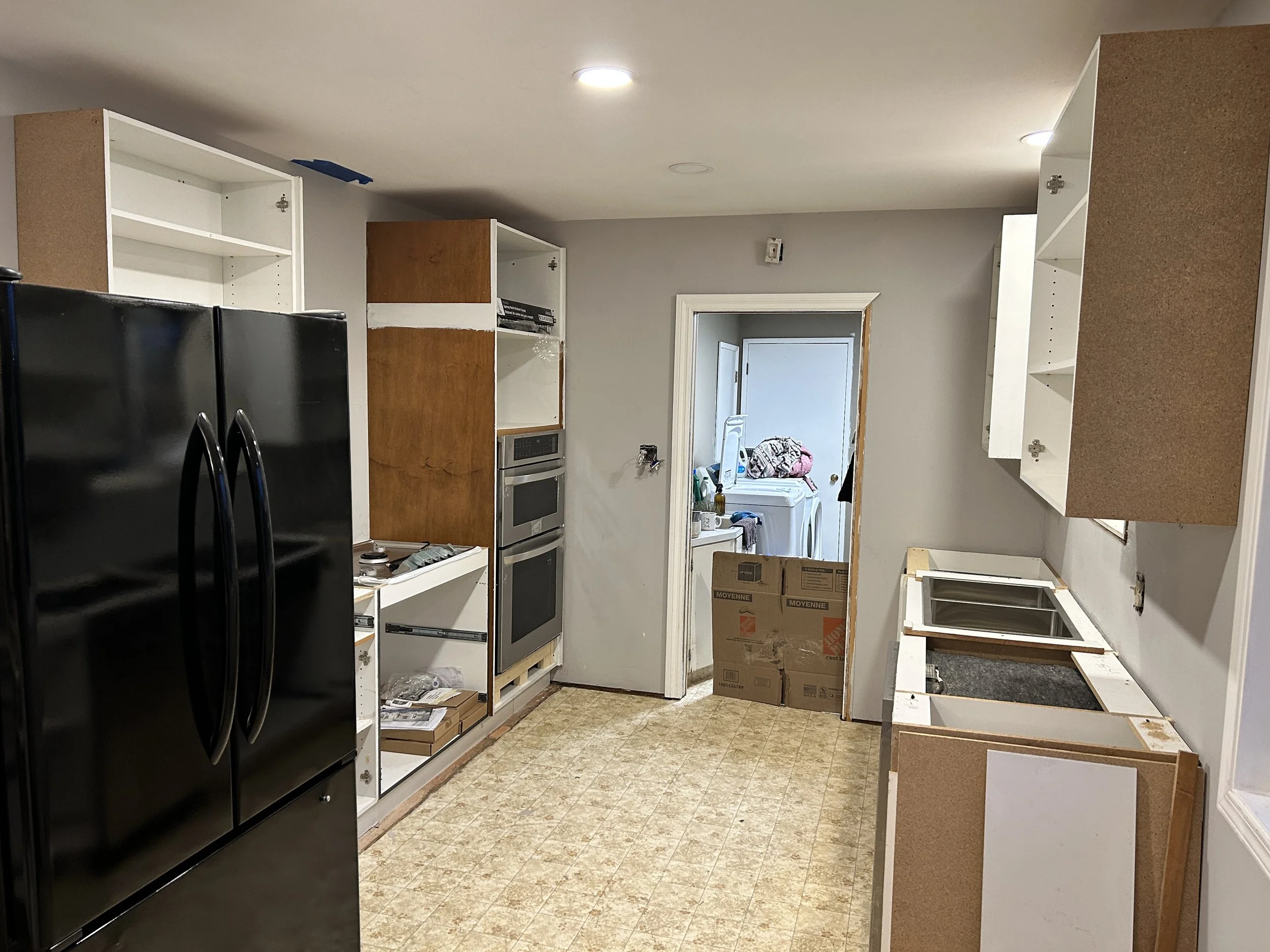 Used kitchen cabinets installed, ready for countertops and paint.