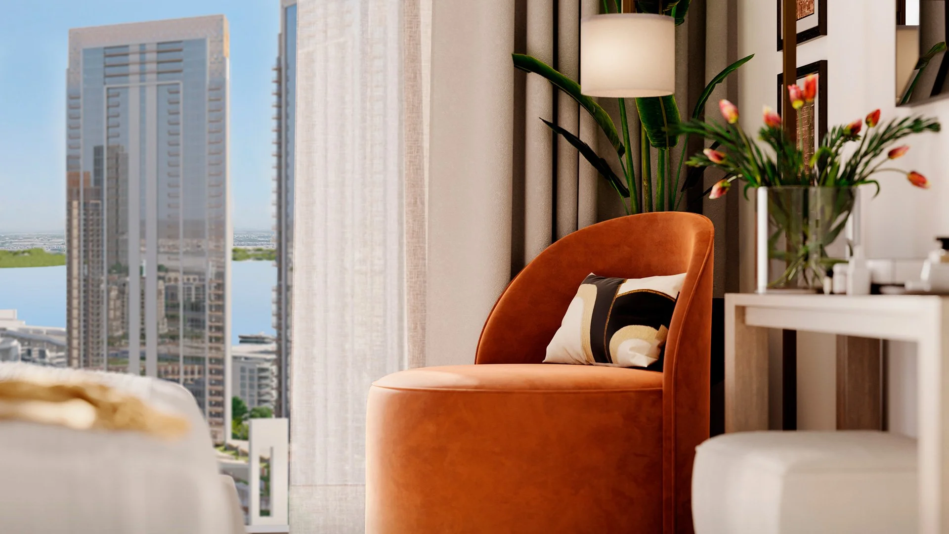 A cozy living room corner with a burnt orange velvet chair. There is a decorative pillow on the chair with abstract black, beige, and gold designs. Behind the chair, there are large green plants and a tall white floor lamp. To the right, a white tabl