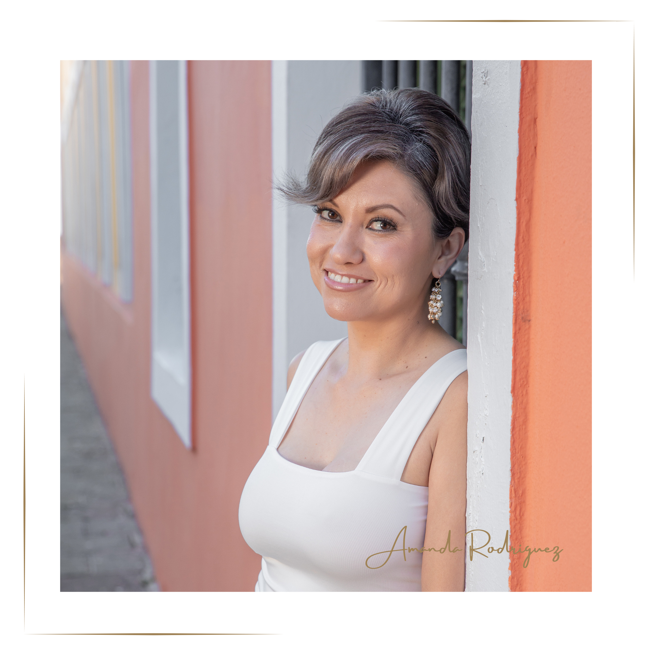 Amanda Rodriguez, owner of Harmony Homes by Amanda — bilingual flip design consultant and home staging expert, smiling in a bright modern setting.