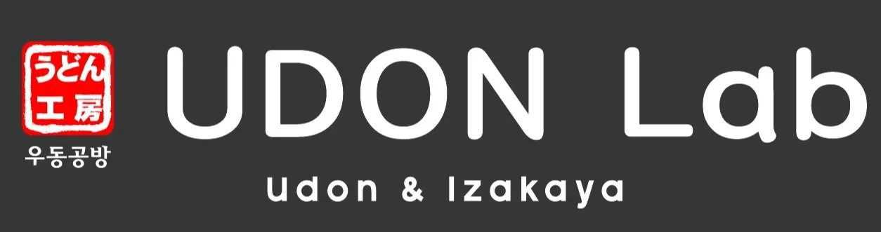 Logo for Udon Lab with Japanese characters, English text 'UDON Lab', and additional text 'Udon & Izakaya' on a dark background.