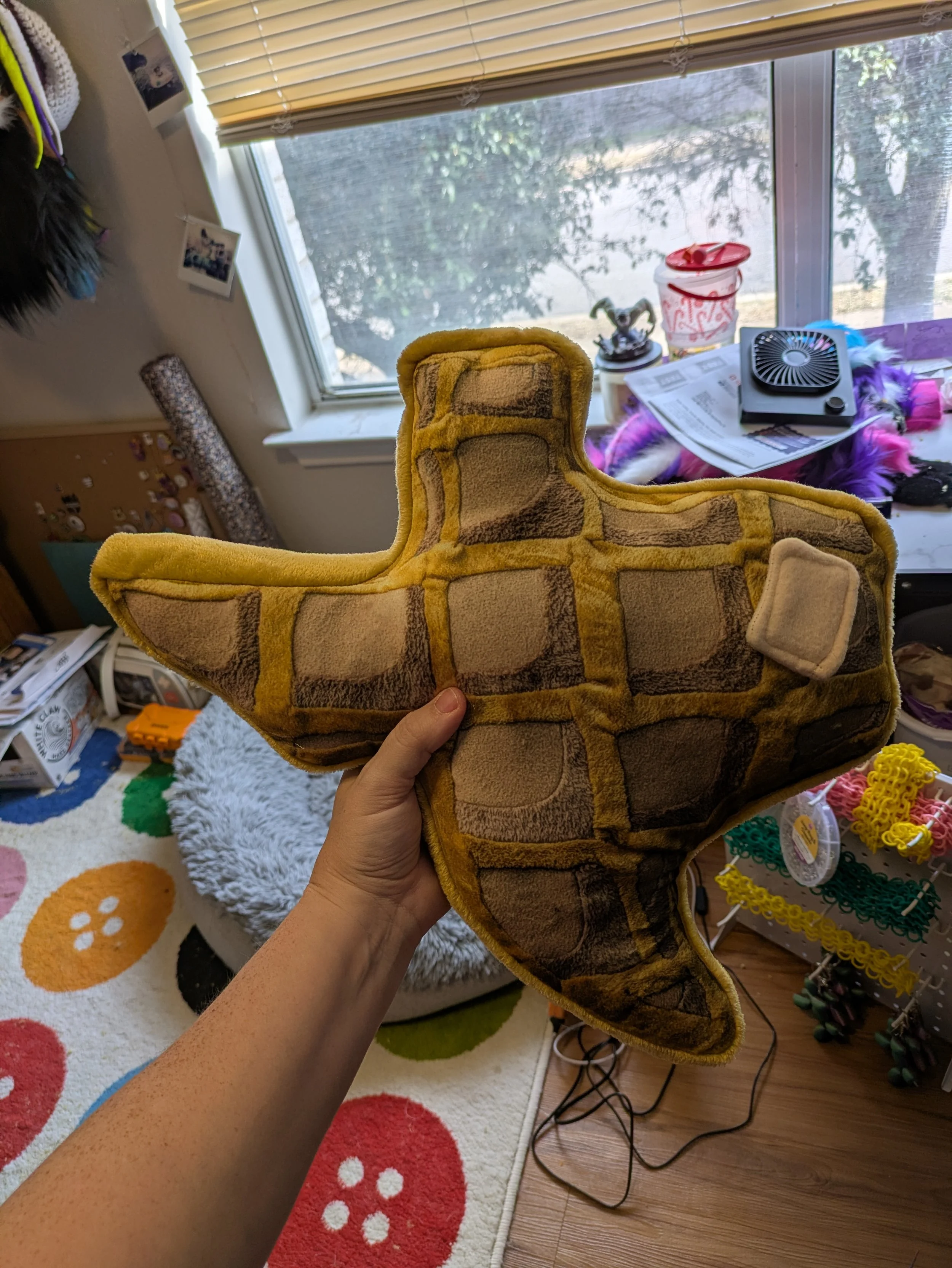 Plush in the shape of a Texas shaped waffle, with a pad of butter