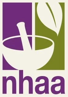 Logo with a purple and green background; features a mortar and pestle and the word 'nhaa' at the bottom.