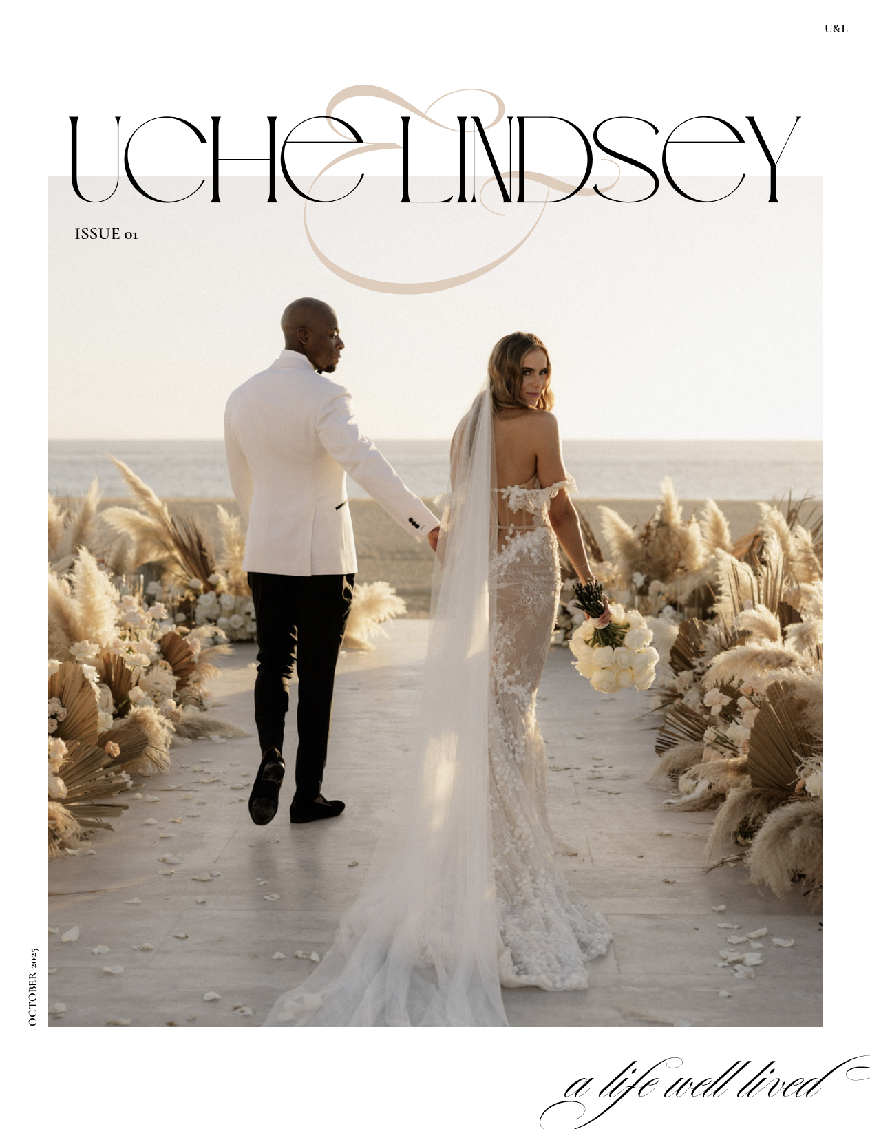 A bride and groom walking hand in hand on a beach during sunset, with the bride holding a bouquet and wearing a lace wedding gown with a long train, and the groom dressed in a white tuxedo jacket and black trousers.