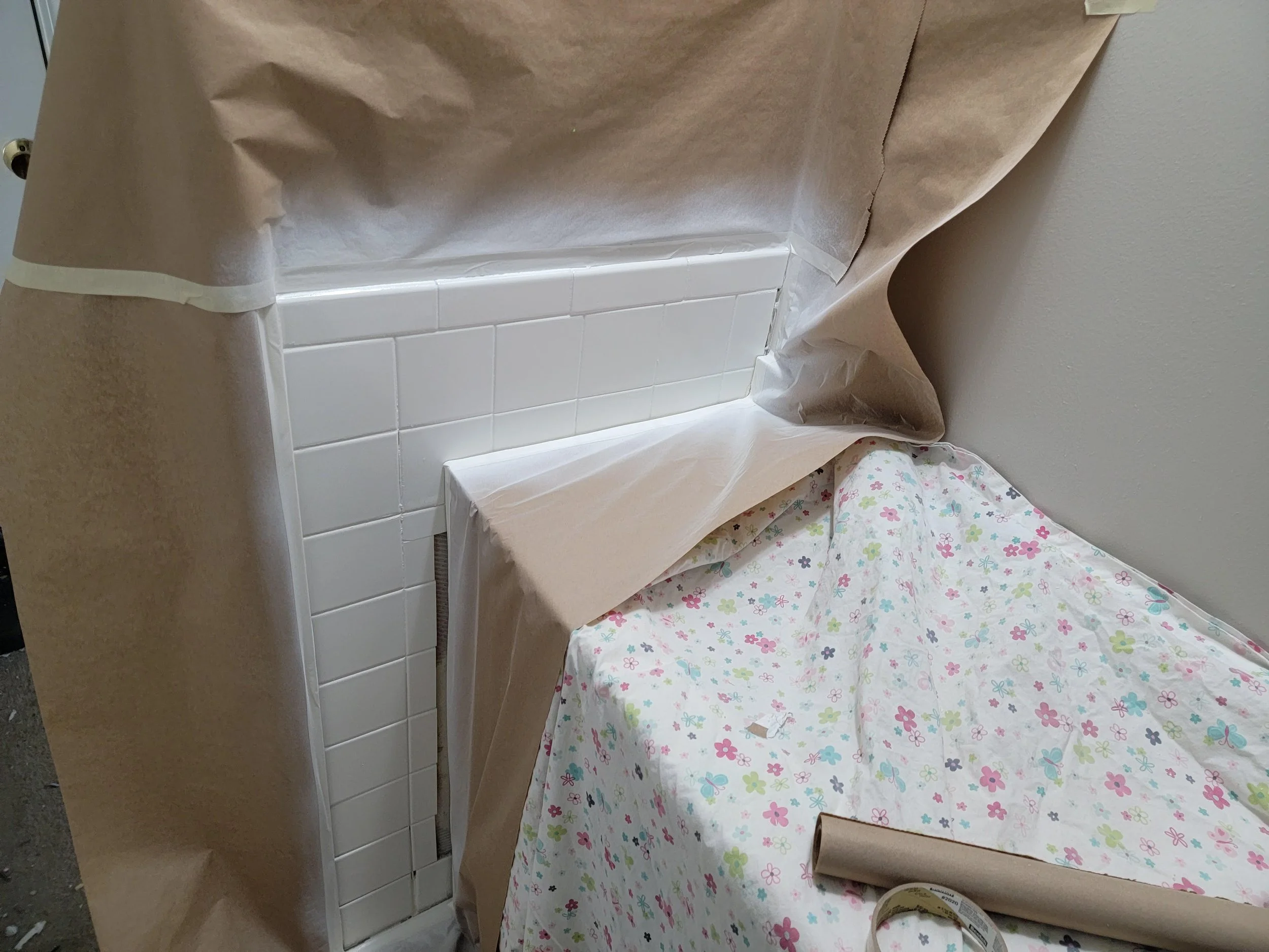 Tile refinishing. Refinishing a tile wall in a bathroom.
