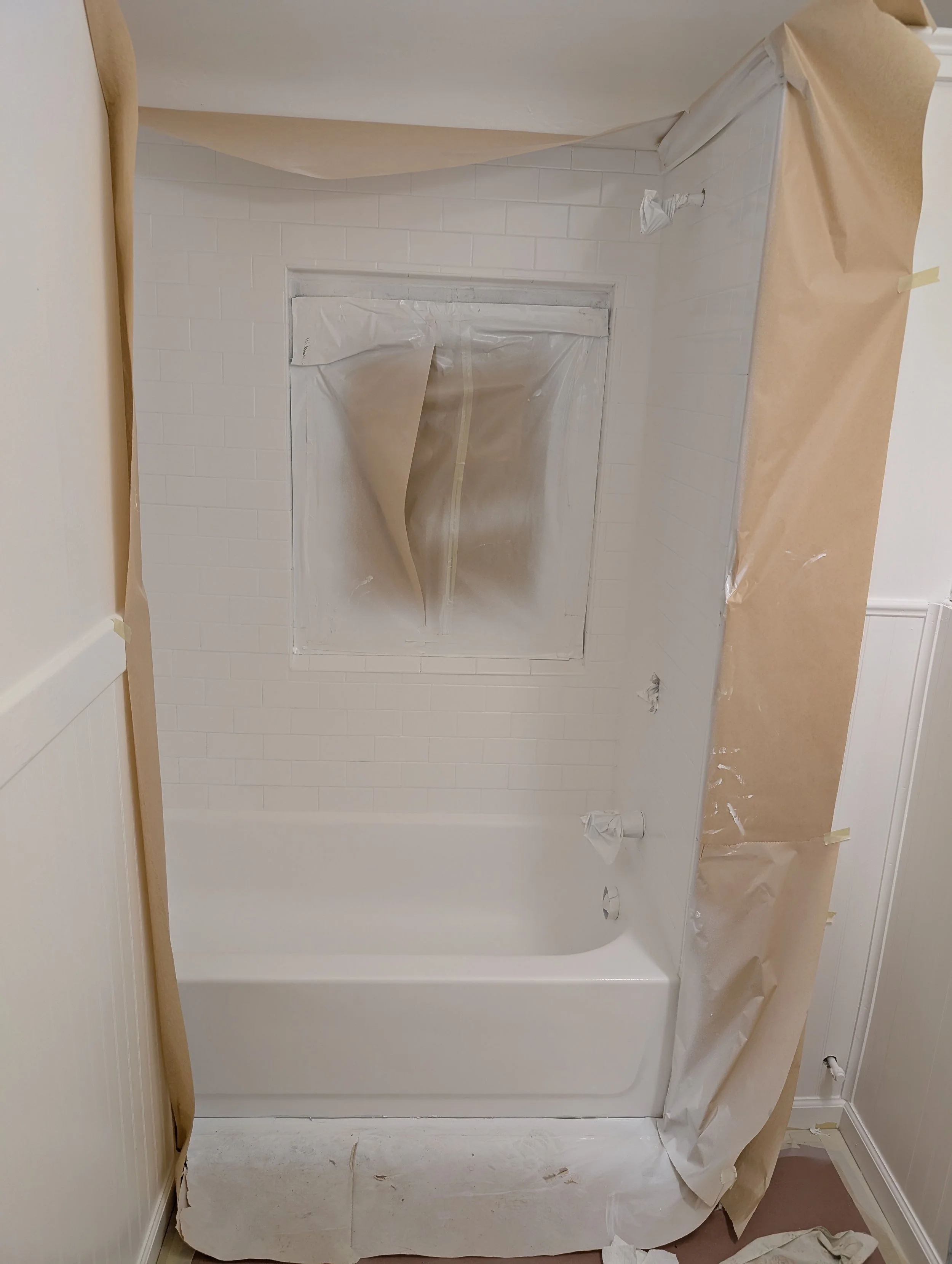 Bathtub and surround refinishing. Refinished in white with slip resistant bottom.