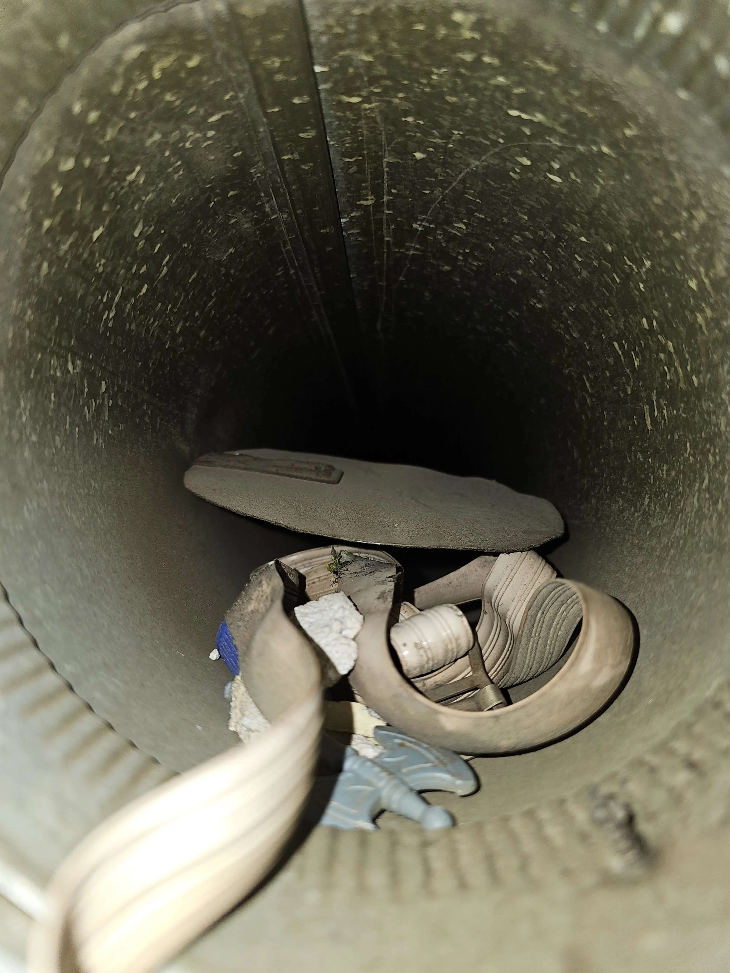 More debris in a residential round duct. Air duct cleaning.