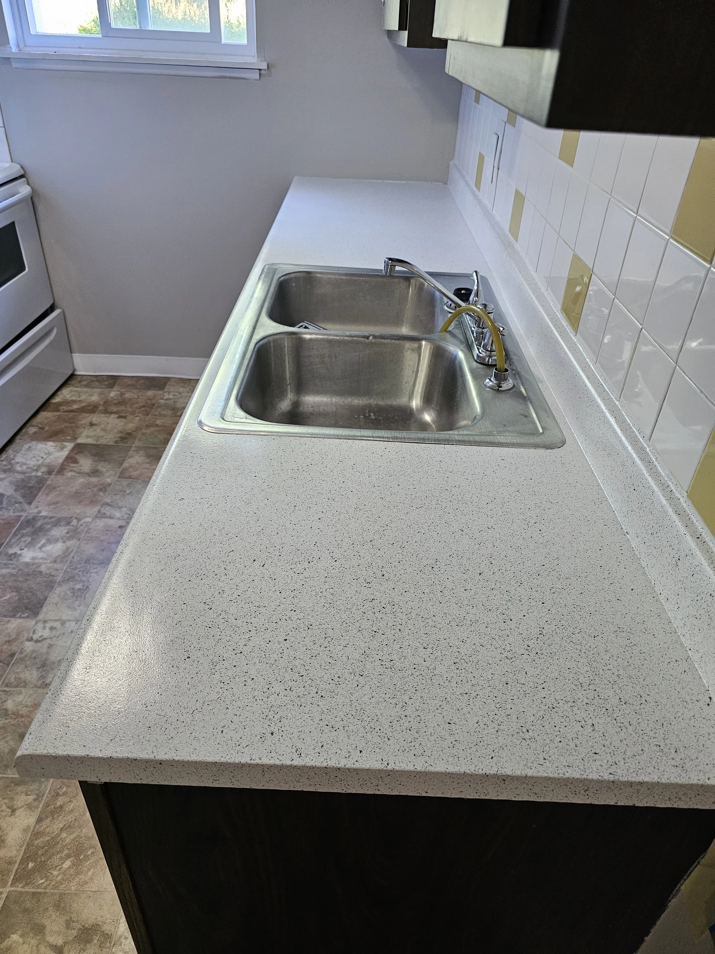 We refinished it in multi color for a bit of a custom look. Countertop refinishing.