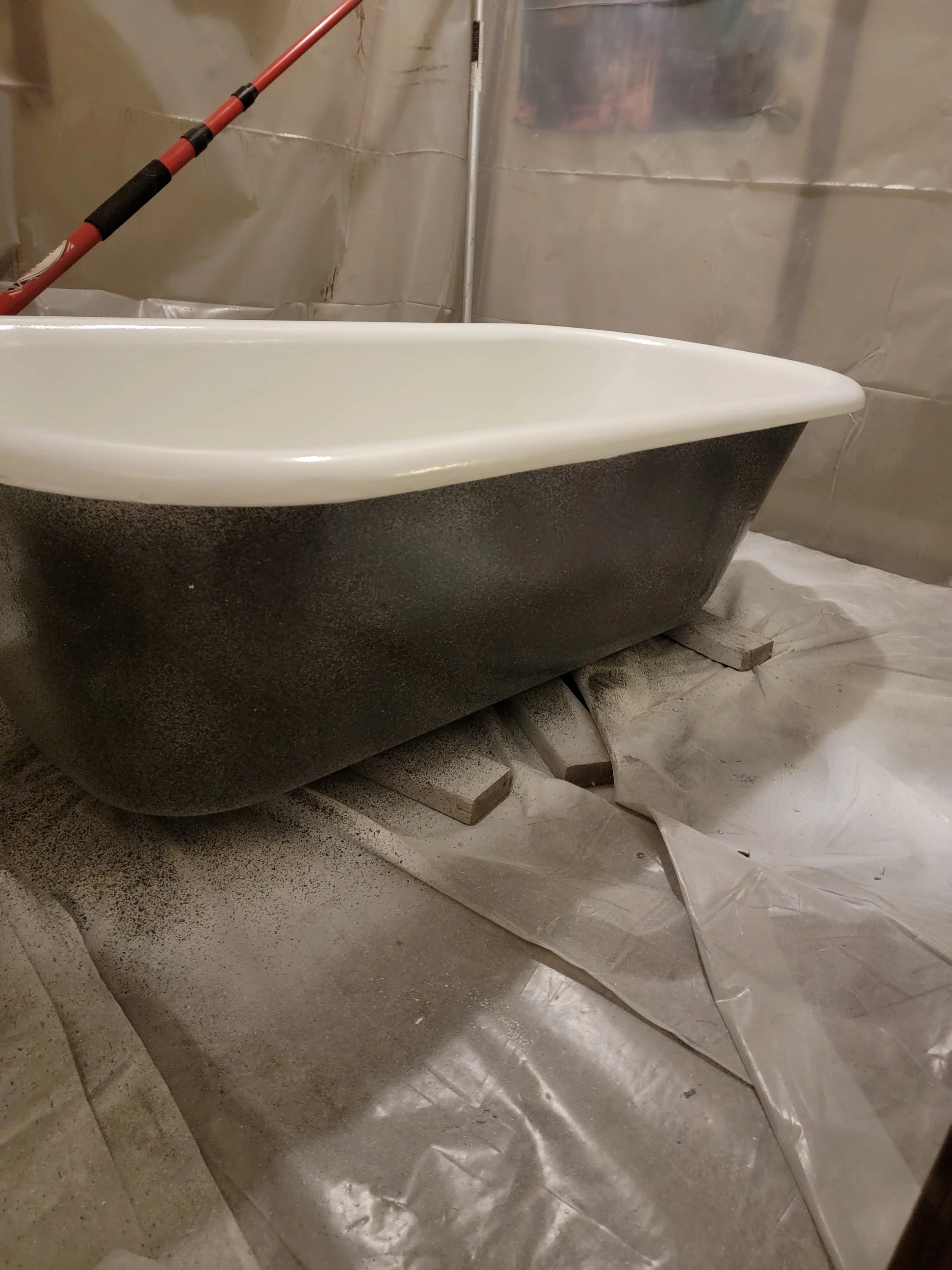 This claw foot bathtub sat in the woods for decades. We refinished the inside in white, the outside in starry night multi spec, and it now sits outside of our shop.