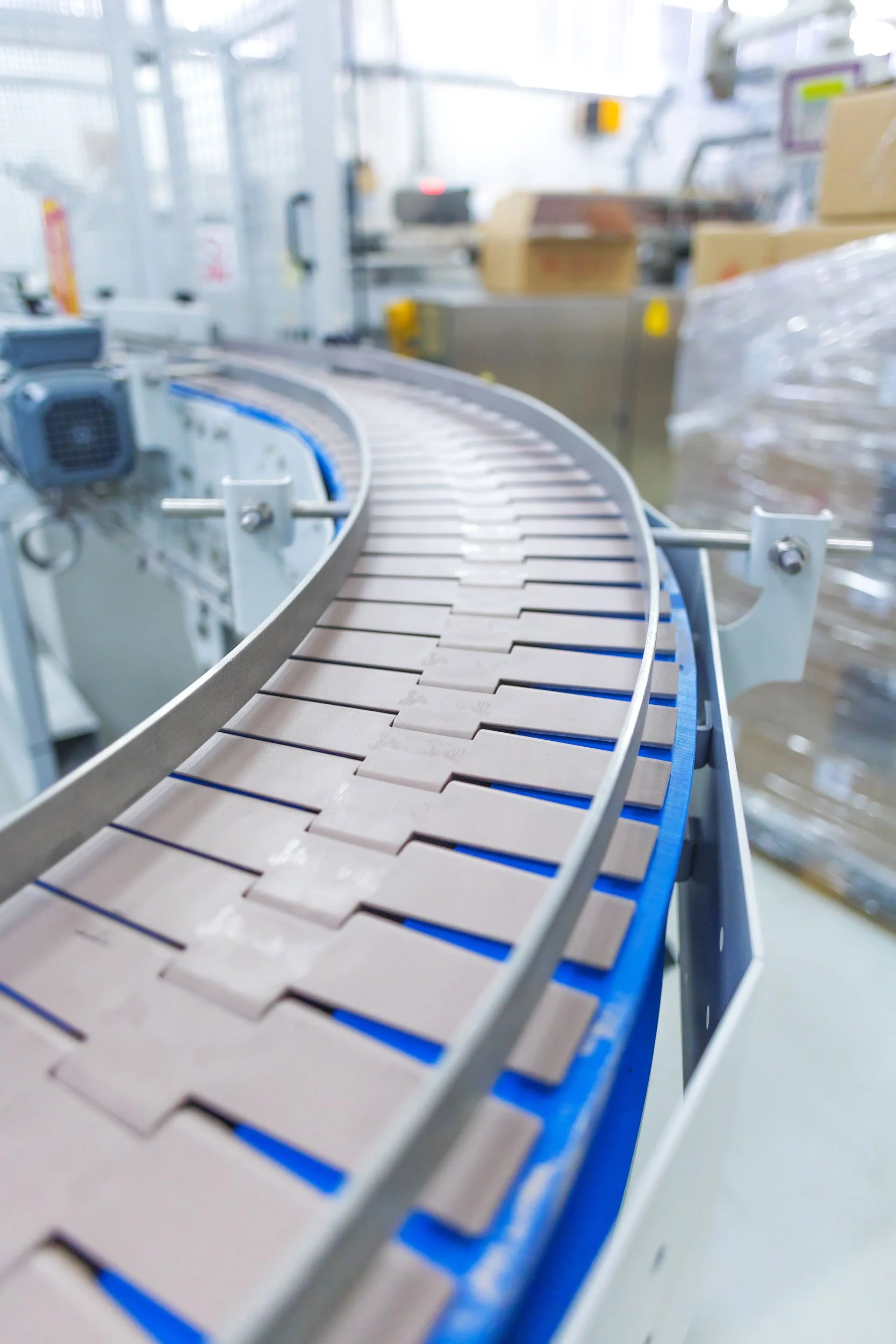 Close-up of a conveyor belt in a manufacturing or packaging facility.
