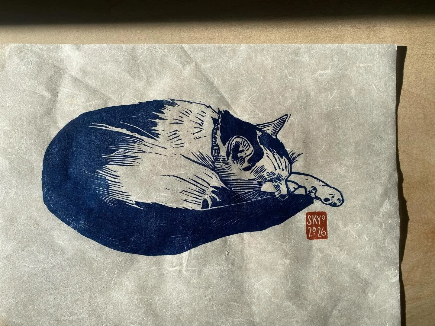 New linocut prints in the works for the upcoming show at @mooresvilleart ! My sweet boy cat, Pistachio, in Prussian blue ✨