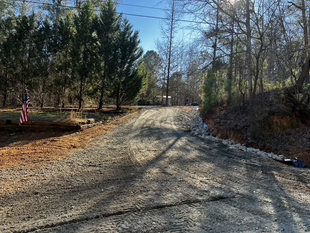 Finished gravel driveway with visible grading and drainage work, completed as part of ASG Dirtworx’s rural property access improvement.