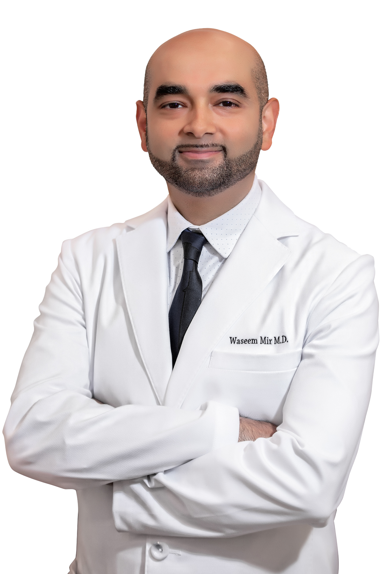 Portrait of a male doctor in a white coat with arms crossed, smiling at the camera. The coat has the name 'Waseem Mir M.D.' embroidered on it.
